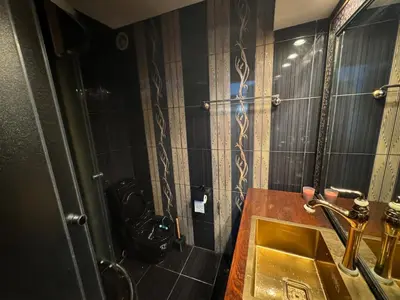 a bathroom with a sink and a shower with a mirror at Retro Gem in Sofia