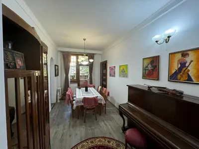 a dining room with a table and a piano at Retro Gem in Sofia