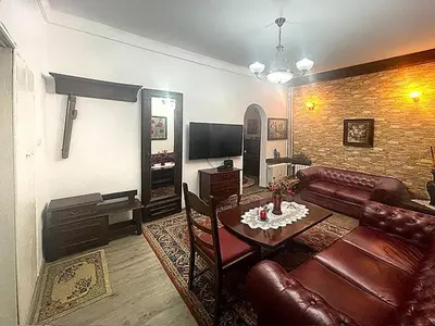 a living room with a couch and a table at Retro Gem in Sofia
