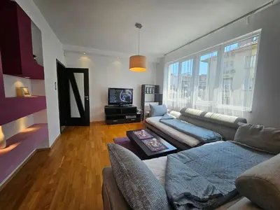 a living room with a couch and a tv at Simply The Best - Vitosha blvd in Sofia
