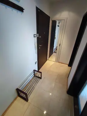 a view of a hallway with a couch and a door at Simply The Best - Vitosha blvd in Sofia