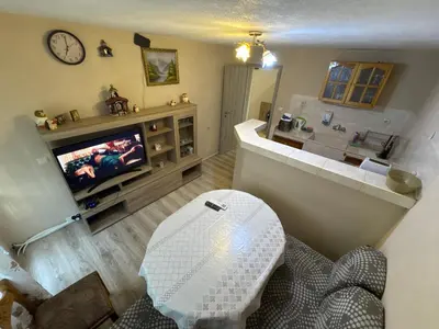a living room with a tv and a couch at DJOKI Apartment in Sandanski