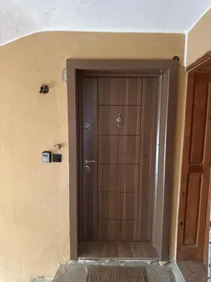 a wooden door in the corner of a room at DJOKI Apartment in Sandanski