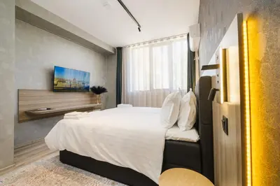 a bedroom with a large white bed in a room at А17 Plovdiv Apartments - Next to Rowing Channel and University hospitals in Plovdiv