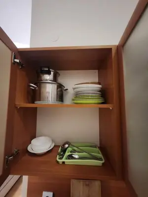 a cupboard with plates and dishes in a kitchen at Borovets Violet by Ski slopes in Borovets