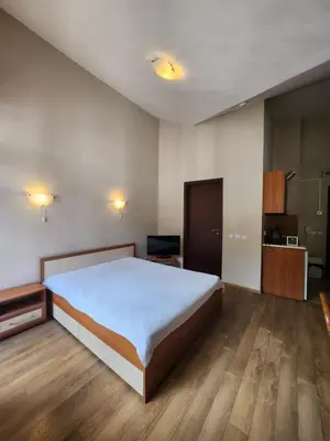 a bedroom with a large bed and wooden floors at Borovets Violet by Ski slopes in Borovets