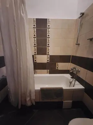 a bathroom with a bath tub and a toilet at Borovets Violet by Ski slopes in Borovets