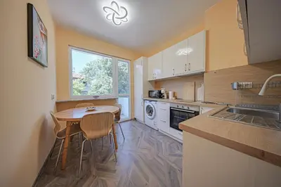 a kitchen with a small table and a window at Oranssi Sunset - Free Parking in Sofia
