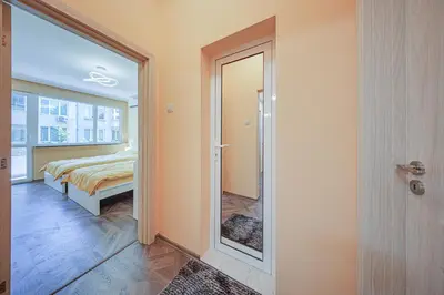 a bedroom with a glass door leading to a bed at Oranssi Sunset - Free Parking in Sofia