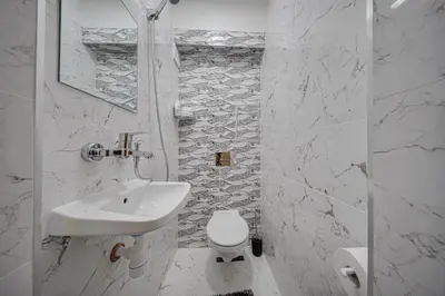 a white bathroom with a sink and a toilet at Oranssi Sunset - Free Parking in Sofia