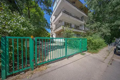 a green gate in front of a building at Oranssi Sunset - Free Parking in Sofia