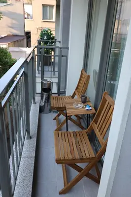 two chairs and a table on a balcony at Good Mood Apartments & Parking in Plovdiv