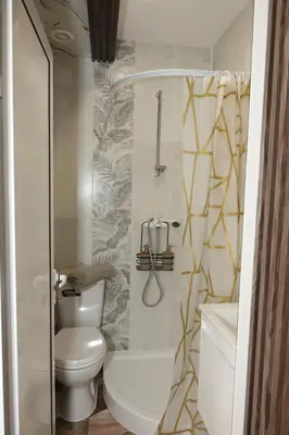 a small bathroom with a toilet and a shower at Good Mood Apartments & Parking in Plovdiv
