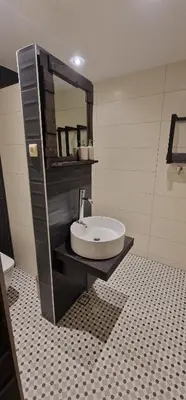 a bathroom with a sink and a mirror at Boutique Apartment Katerina in Bansko