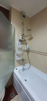 a bathroom with a shower and a white sink at Beby's Apartment - Tamplier in Bansko
