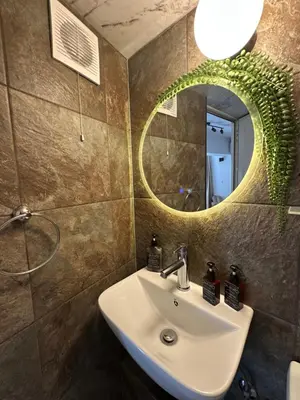 a bathroom with a sink and a mirror at Studio with TERRACE - city center in Plovdiv