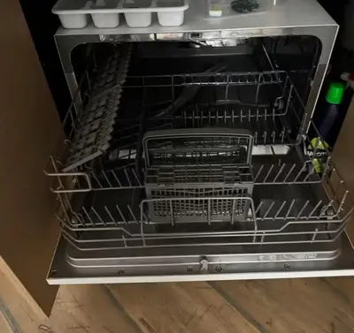an open oven with its racks in it at Уютни планински апартаменти с басейн в комплекс Алпин Лодж in Bansko