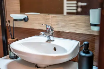 a bathroom sink with a faucet on a counter at Green Life Cozy Studio Bansko in Bansko