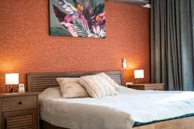 a bedroom with a bed and a painting on the wall at Green Life Cozy Studio Bansko in Bansko
