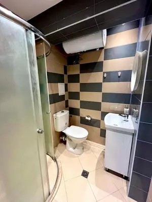 a bathroom with a toilet and a sink at Winter Palace Vitosha View Studio in Sofia