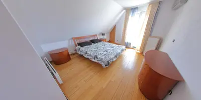 a bedroom with a bed and a wooden floor at Spacious Penthouse Sofia in Sofia