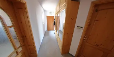 a hallway with a wooden door and a room at Spacious Penthouse Sofia in Sofia