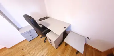 a desk with a printer and a chair in a room at Spacious Penthouse Sofia in Sofia