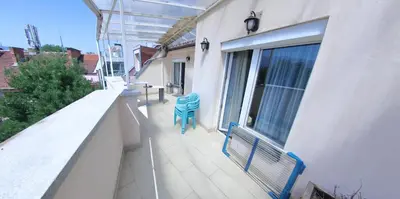 a balcony with a blue bench and a window at Spacious Penthouse Sofia in Sofia