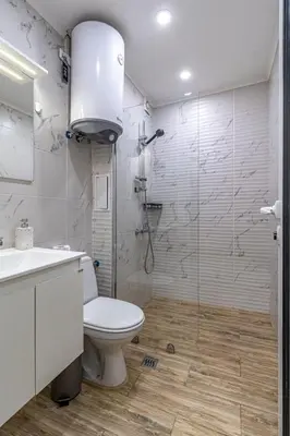 a bathroom with a toilet and a glass shower at Ishirkov Residence Studio in Sofia