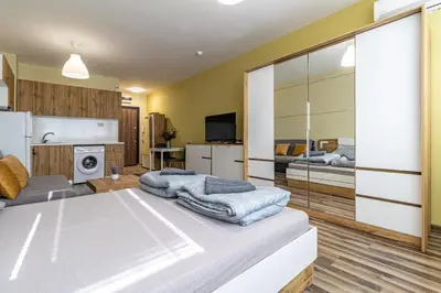 a living room with a bed and a kitchen at Ishirkov Residence Studio in Sofia