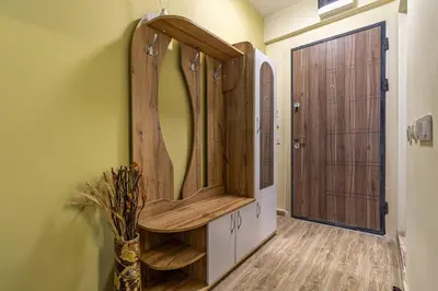 a dressing room with a mirror and a wooden door at Ishirkov Residence One Bedroom Apartment in Sofia