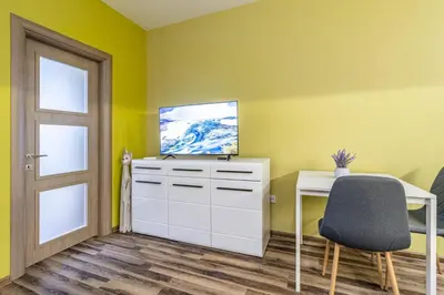 a room with a desk and a television and a chair at Ishirkov Residence One Bedroom Apartment in Sofia