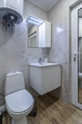 a bathroom with a toilet and a sink and a mirror at Ishirkov Residence One Bedroom Apartment in Sofia