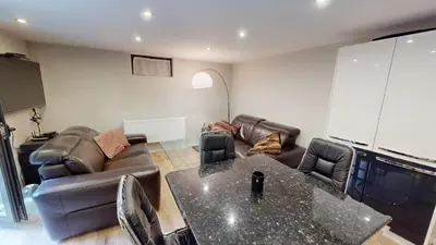 a living room with a couch and a table at Cozy 1BR Flat next to NDK with Private Patio in Sofia