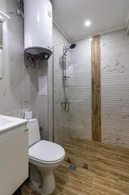 a bathroom with a toilet and a shower at Ishirkov Residence Studio With Mountain VIew Balcony and Underground Parking in Sofia