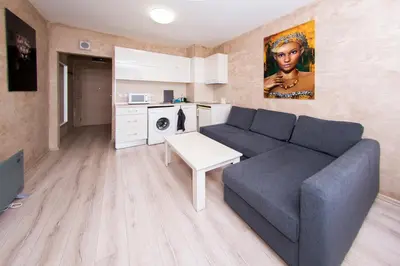 a living room with a couch and a kitchen at Easy studios in Sofia
