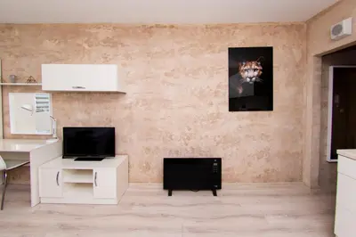 a living room with a desk and a television at Easy studios in Sofia