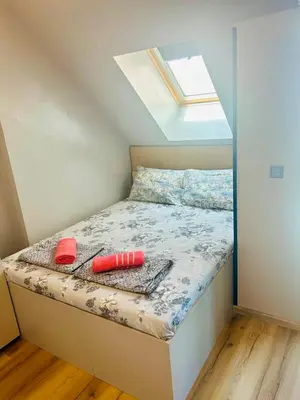 a small bedroom with a bed with a window at Yosifov apartments in Sofia