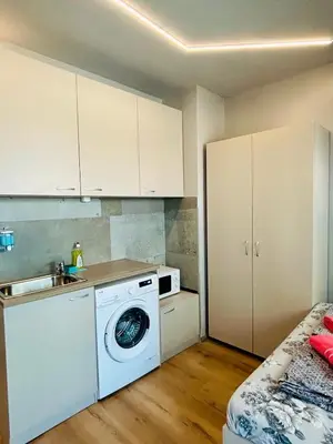 a kitchen with a washing machine and a sink at Yosifov apartments in Sofia
