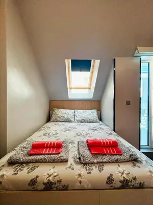a bedroom with a bed with two pillows on it at Yosifov apartments in Sofia