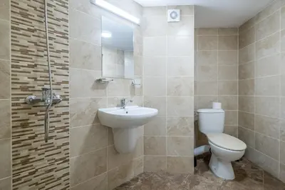 a bathroom with a toilet and a sink and a shower at Yubim rooms in Sofia