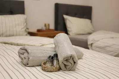a bed with towels and a basket on it at Good Mood Apartments & Parking 2 in Plovdiv