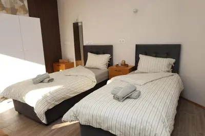 two beds sitting next to each other in a bedroom at Good Mood Apartments & Parking 2 in Plovdiv