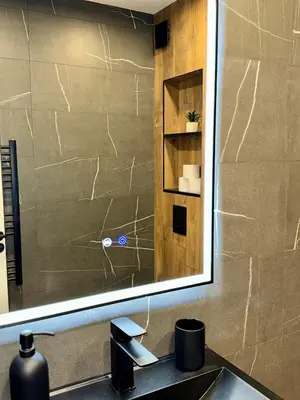 a bathroom sink with a large mirror above it at Selena Apartment 50m to Metro with Free Parking in Sofia
