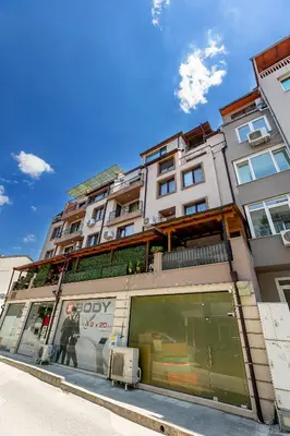 a building on a street with a store at Elena apartment in Sandanski