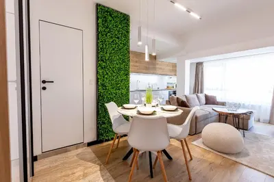 a dining room and living room with a table and chairs at Elena apartment in Sandanski