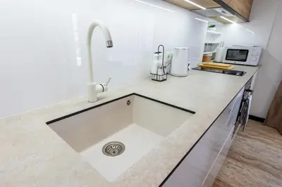 a kitchen counter with a sink in a kitchen at Elena apartment in Sandanski