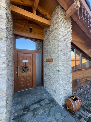a front door of a house with a table and chairs at Villa Stemara in Razlog
