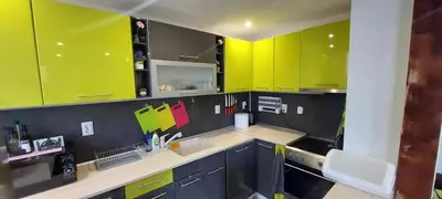 a kitchen with bright green cabinets and a sink at Stoykite view in Stoykite