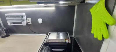 a kitchen with a stove and a green oven mitt at Stoykite view in Stoykite